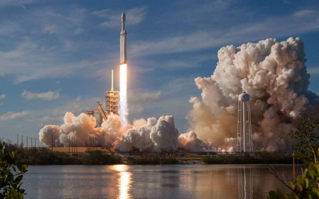 A rocket lifting off from Kennedy Space Center in a cloud of exhaust